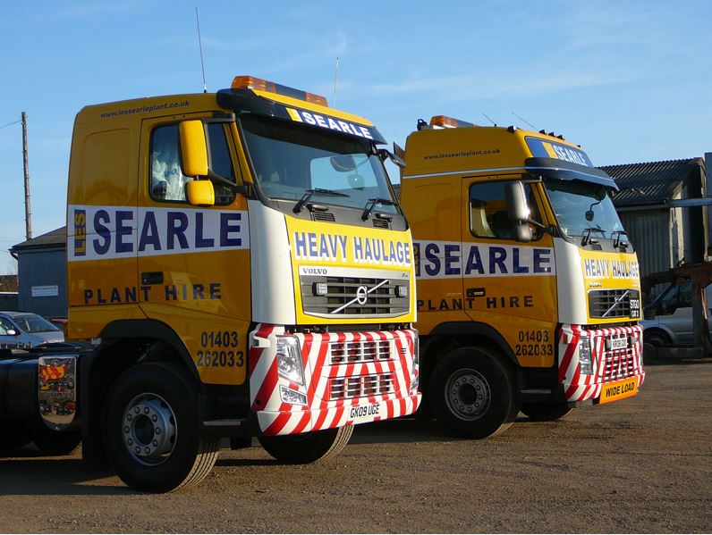 Two Heavy Haulage trucks with vehicle graphics